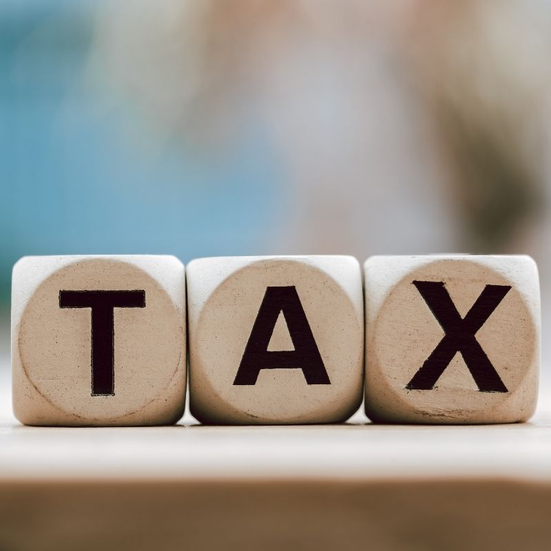 Wooden blocks spelling “TAX”