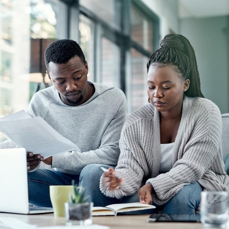 Couple reviewing their finances and financial documents at home